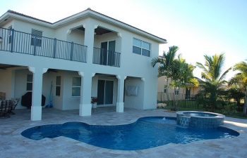 backyard swimming pool with jacuzzi and paver deck