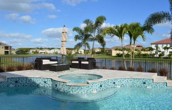 backyard swimming pool with light blue water color and jacuzzi