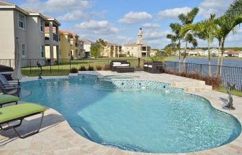 backyard swimming pool with light blue water color and jacuzzi