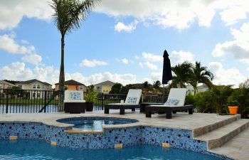 sunbeds on a pool patio with built-in jacuzzi