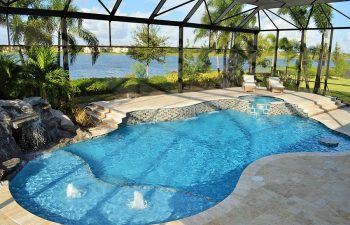 glass enclosed swimming pool with jacuzzi and waterfalls