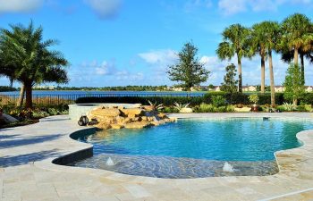 backyard swimming pool with a waterfall