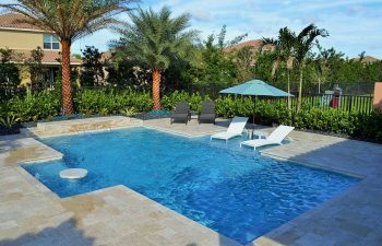 backyard swimming pool with sunbeds and sun umbrella
