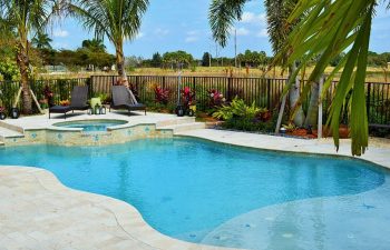 backyard beach entry pool with paver patio