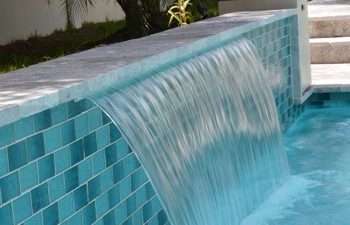 backyard pool with a waterfall