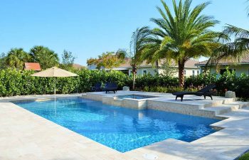 backyard swimming pool with jacuzzi and Travertine deck