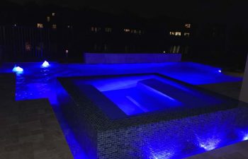 night view of a patio with spa pools
