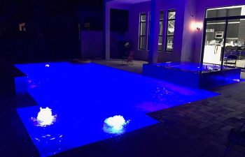 night view of a patio with spa pools