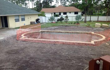 backyard swimming pool under construction