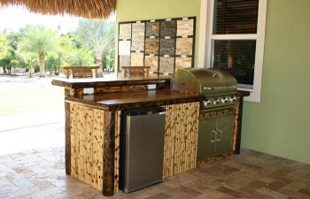 patio with tiki roof and outdoor kitchen