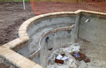 backyard swimming pool under construction