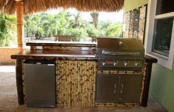 patio with tiki roof and outdoor kitchen