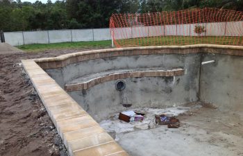 backyard swimming pool under construction