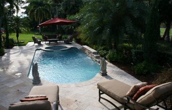 landscaped garden with a swimming pool and outdoor furniture on a deck