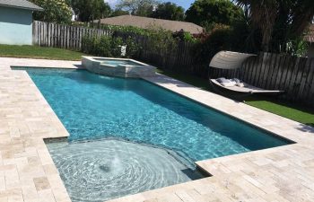 backyard swimming pool with jacuzzi and paver deck