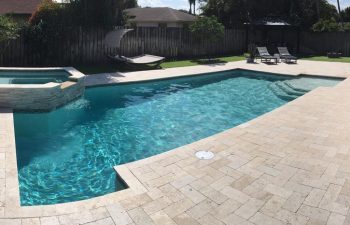 backyard swimming pool with jacuzzi and paver deck