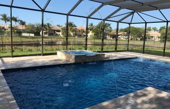 glass enclosed swimming pool with jacuzzin and built-in fountains