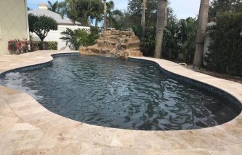 backyard swimming pool with waterfall and dark water color