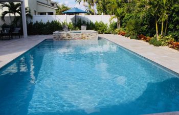 backyard pool and jacuzzi with Travertine walls