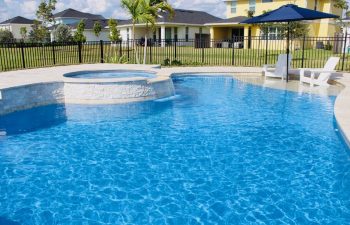 backyard swimming pool with jacuzzi and waterfall