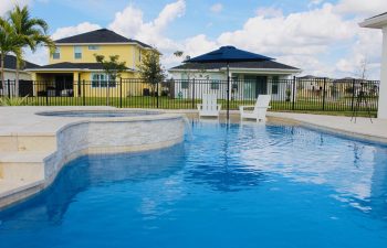 backyard swimming pool with jacuzzi and waterfall