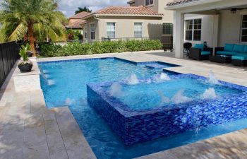 backyard swimming pool with and jacuzzi and built-in waterfall and fountains