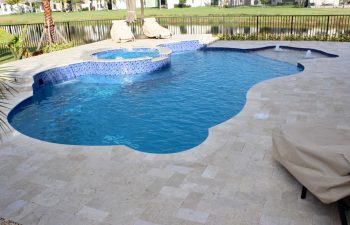 backyard swimming pool with built-in fountains and waterfalls