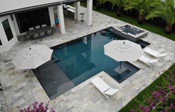 backyard swimming pool with jacuzzi and artistic pavers patio