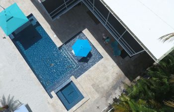 aerial view of a modern backyard swimming pool with jacuzzi