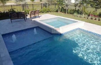 swimming pool with jacuzzi and built-in fountains