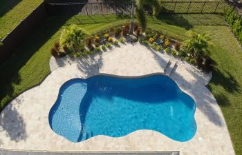 aerial view of a landscaped backyard with a swimming pool