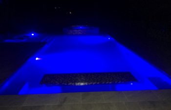 night view of a patio with spa pools