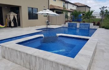 modern backyard swimming pool with jacuzzi and waterfall