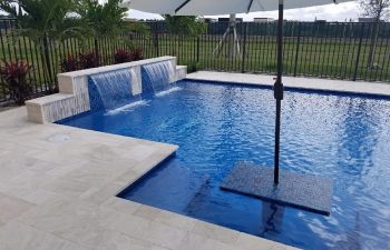 modern backyard swimming pool with jacuzzi and waterfall