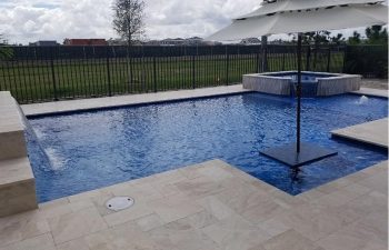 modern backyard swimming pool with jacuzzi and waterfall