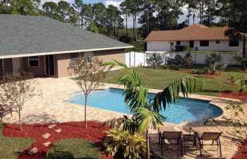 finished backyard swimming pool with paver deck