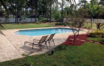 finished backyard swimming pool with paver deck