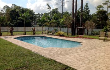 finished backyard swimming pool with paver deck