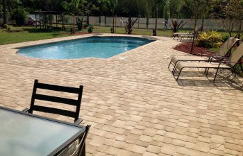 finished backyard swimming pool with paver deck