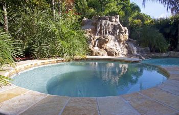 backyard swimming pool with waterfall