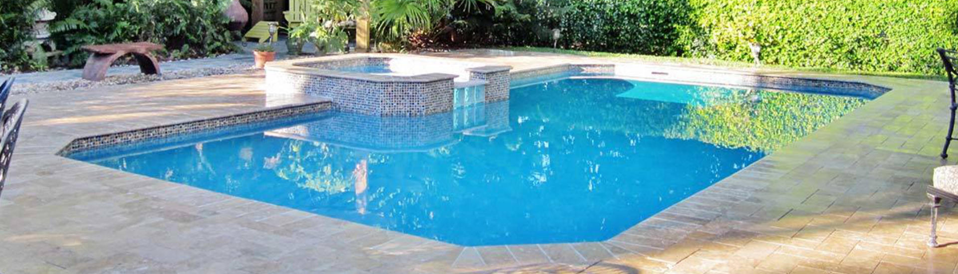 backyard swimming pool with and jacuzzi and paver deck